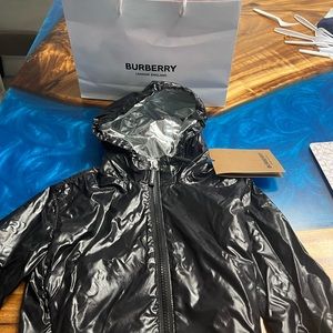 A beautiful kids 2t lightweight rain jacket in black.